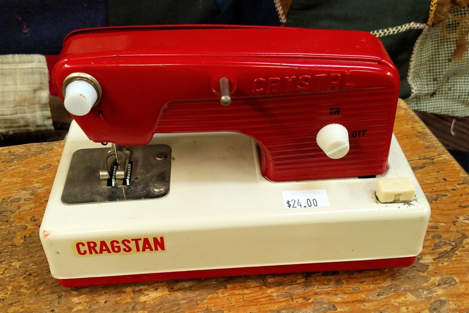 Bright Red Toy Sewing Machine for a Cheerful Sewing Room Decoration.