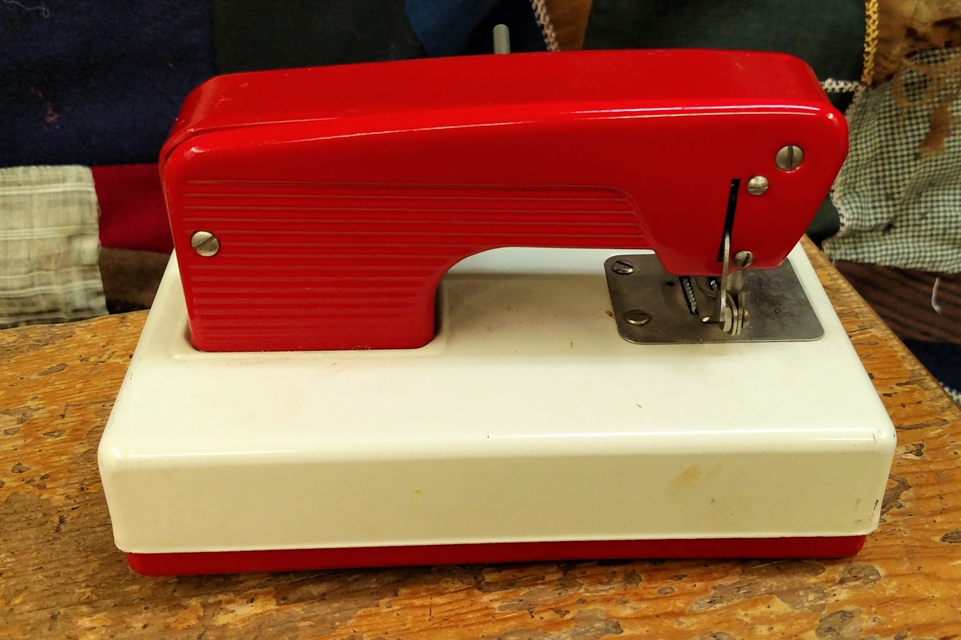 Bright Red Toy Sewing Machine for a Cheerful Sewing Room Decoration.