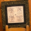 Picture of Four Happy Pumpkins are Hand Embroidered Table Topper
